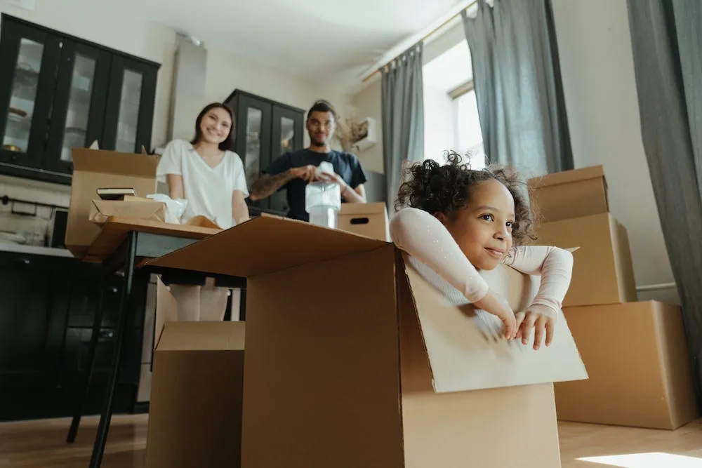 family family in kitchen moving boxes and child